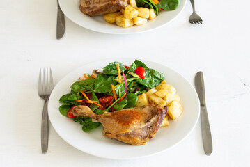 Duck leg confit with salad and potatoes