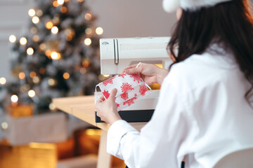 DIY Christmas gifts ideas. Girl showing a handmade face mask, Christmas tree on the background....