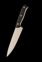 A large kitchen knife with a black handle on a dark background. Knife with a wide sharp blade. Not scratched steel surface of the knife blade.