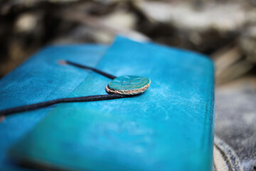 Macro close up of simple lock of blue diary book with vintage leather binding (selective focus on...