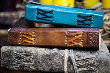 Close up of stack isolated blank spine of three old blue and brown books with vintage leather...