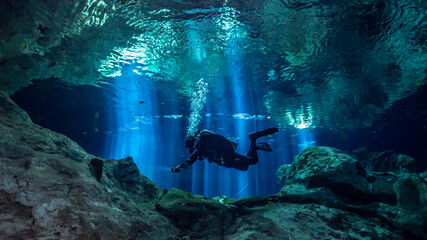 Cenote Tajma Ha with light rays Underwater in Yucatan, Mexico