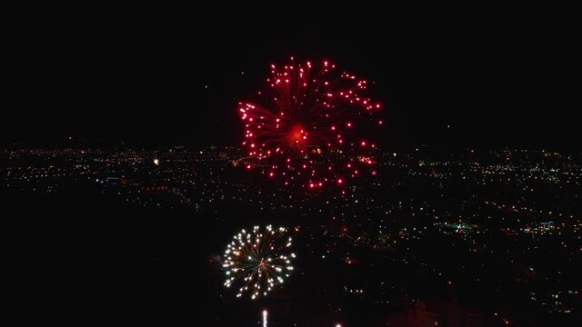 Top view from the air on the beautiful fireworks in night sky. New Year celebration. Beautiful firework over the whole big city. Celebrate christmas.
