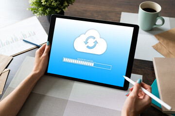 Cloud synchronization progress bar on tablet screen. Data storage and protection. Technology and...