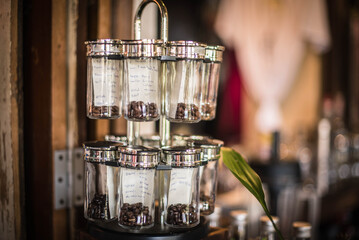 Various varieties of coffee brought into glass straws for customers to choose from in front of a coffee shop at Hua Takhe Old Market, Thailand