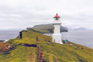 View of lighthouse at Mykines island in Faroe Islands, North Atlantic Ocean.