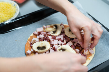 little girl makes pizza at home