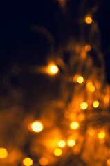 Abstract pattern of golden bokeh lights on dark background