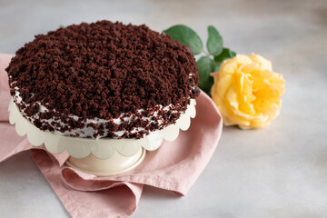 delicious chocolate cake with cream on gray background with yellow rose. Women's Day, Valentine's Day. space for text