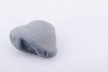 Fototapeta na wymiar Natural river stone with heart shape and white background