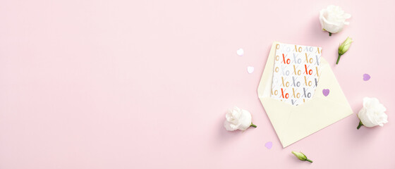 Happy Valentines Day banner template. Flat lay paper envelope, greeting card and rose flowers on pink background. Top view with copy space.
