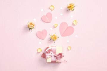 Happy Valentines day flat lay composition. Gift box, paper hearts, roses and confetti on pink background. Romance, love concept.