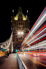Fototapeta na wymiar Traffic light trails flowing over Tower Bridge in London