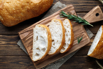 Italian ciabatta bread on wooden table.