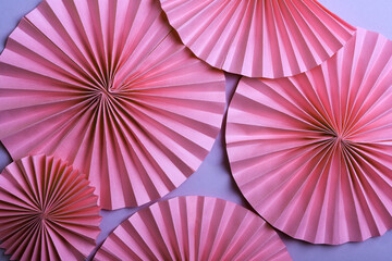 Pink circle  paper fans on   violet background
