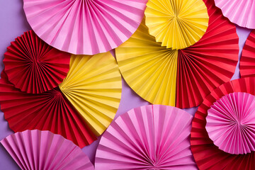 Colorful circle  paper fans on violet background