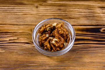 Cores of walnut in glass bowl on a wooden table