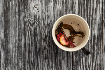 Remains of berries and herbs in empty teacup. Remainder of tea - organic waste.