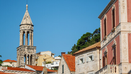 Fototapeta na wymiar View of the bell tower of Hvar Cathedral of Saint Stephen and house roofs