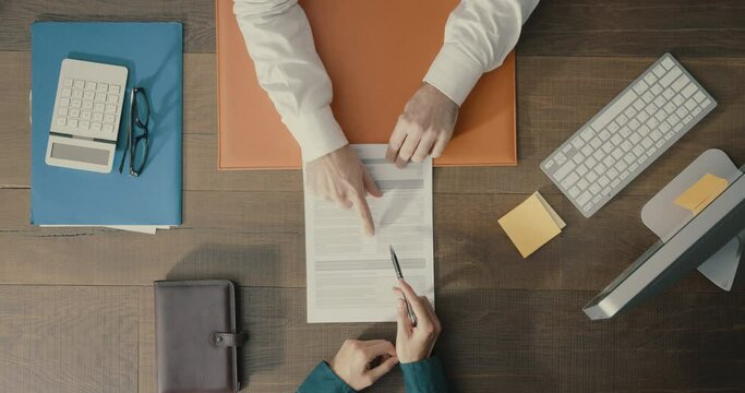 Businessman signing a contract in the office