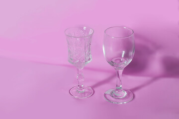 Two wine glasses on the pink background