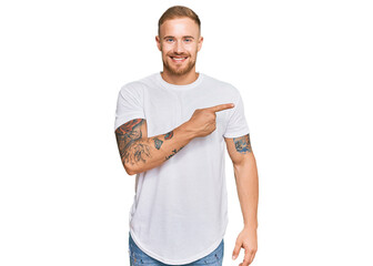 Young irish man wearing casual clothes cheerful with a smile of face pointing with hand and finger...