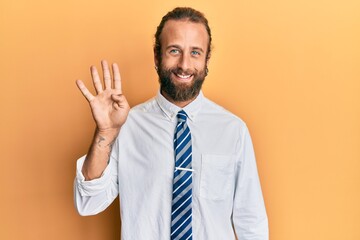 Handsome man with beard and long hair wearing business clothes showing and pointing up with fingers number four while smiling confident and happy.