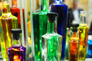 Glass bottles with multi-colored alcohol. Close-up