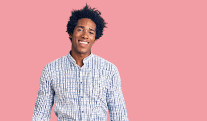Handsome african american man with afro hair wearing casual clothes looking positive and happy standing and smiling with a confident smile showing teeth