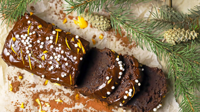 Chocolate Cake With Chocolate And Orange. Christmas Tree Branches And Cones. Christmas Log. Festive Sweets.