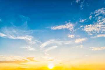 Sky at sunset blue and orange light of the sun through the clouds in the sky