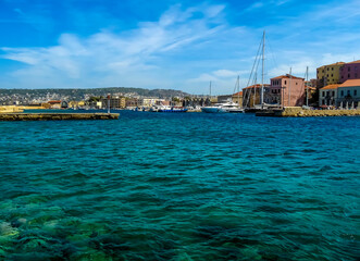 Obraz premium A sea-level view across Chania harbour, Crete on a bright sunny day