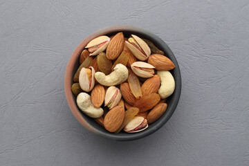 Assorted nuts in a clay bowl. 