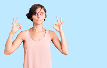 Beautiful young woman with short hair wearing casual style with sleeveless shirt relax and smiling with eyes closed doing meditation gesture with fingers. yoga concept.