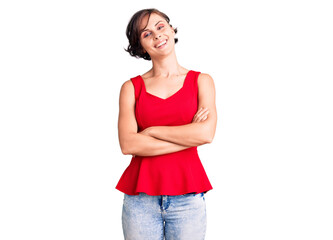 Beautiful young woman with short hair wearing casual style with sleeveless shirt happy face smiling with crossed arms looking at the camera. positive person.