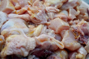 Raw chicken meat kept in a plate for sale in the market. Chicken meat chopped and kept in a plate for cooking in kitchen.