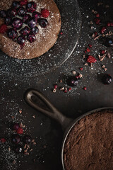 chocolate brownie with berries and powdered sugar