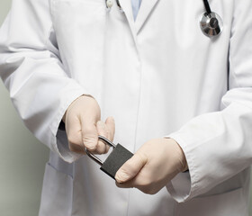 Covid-19 corona virus pandemic isolation lockdown with a doctor and a padlock