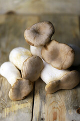 Selective focus. Macro. Raw eringi mushrooms on a wooden surface.
