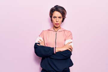 Young beautiful woman wearing sportswear skeptic and nervous, disapproving expression on face with...