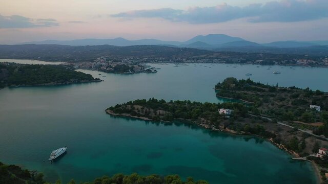 Aerial drone video of famous fjord seaside village and bay of Porto Heli in the heart of Argolida prefecture at sunset, Peloponnese, Greece