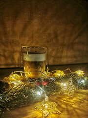 Christmas and new year's composition: a Cup of cappuccino, a branch of spruce and garlands