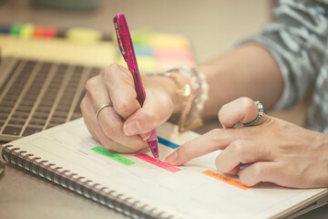 Asian beauties write schedules in their calendars and planning daily appointment in the working...