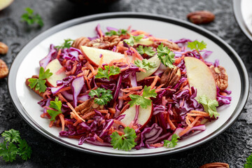 Red Cabbage salad with carrots, apples and pecan nuts. Healthy vegan food