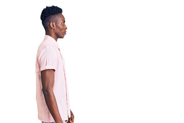 Fototapeta premium Young african american man wearing casual clothes looking to side, relax profile pose with natural face with confident smile.