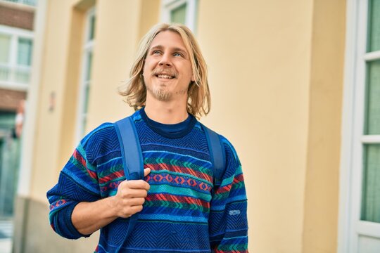 Young scandinavian student man smiling happy standing at the city.