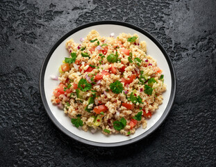 Tabbouleh salad with tomato, cucumber, red onion, bulgur and parsley. Healthy vegan food