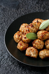 Pork stuffing meatballs with sage and onion in a black plate