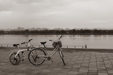 Fototapeta premium desaturated picture of two bicycle parking near riverside