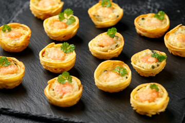 Mini party Fish Pie Food with prawn on rustic stone background